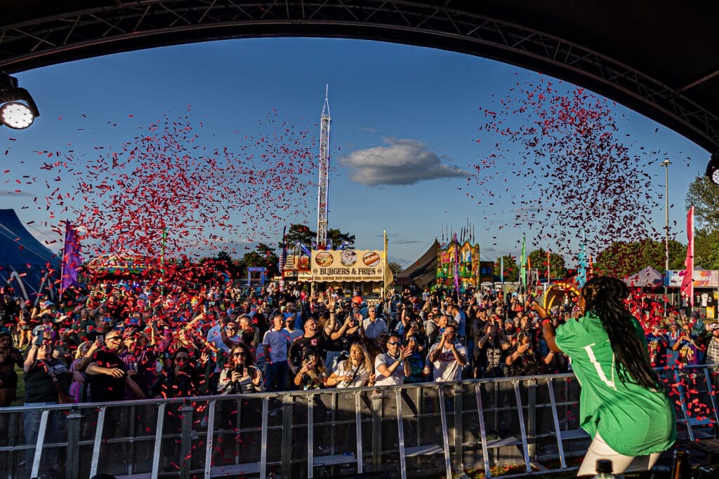Crowd looking at stage with confetti and acts at Meridian Showground